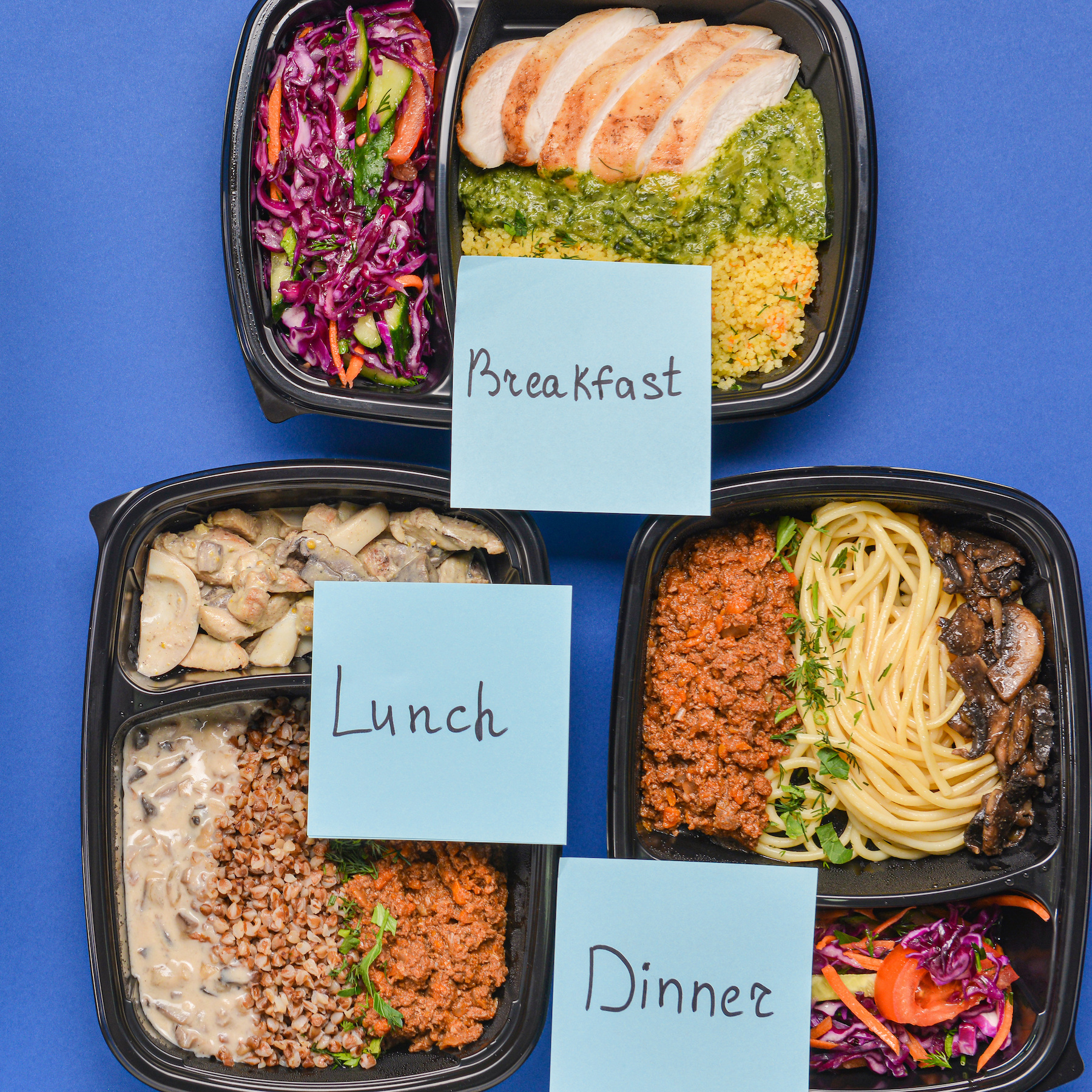 Containers with healthy food and meal plan on color background
