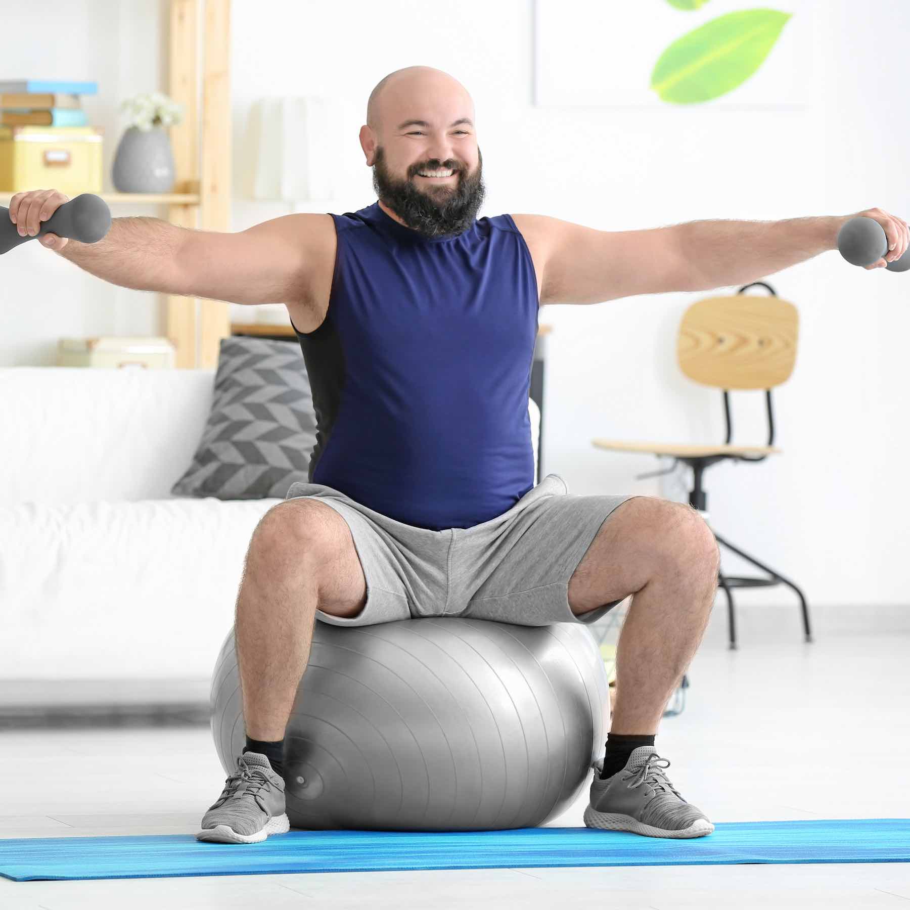 Overweight man doing exercises at home Overweight man doing exercises at home
