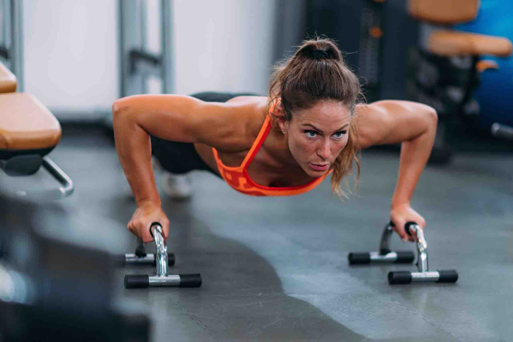 Female Athlete Doing Push-Ups in The Gym